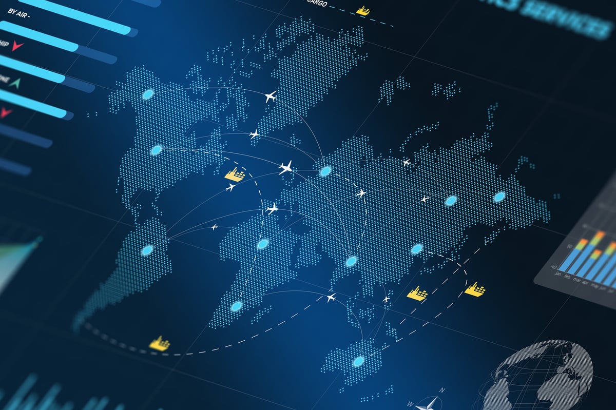 Computer monitor displaying a world map with illuminated global shipping routes and location markers