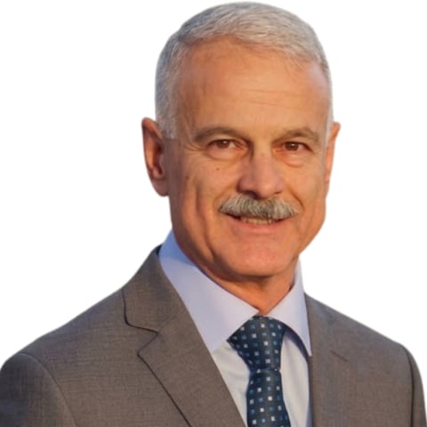 Professional headshot of older man with gray hair and mustache wearing gray suit and blue patterned tie